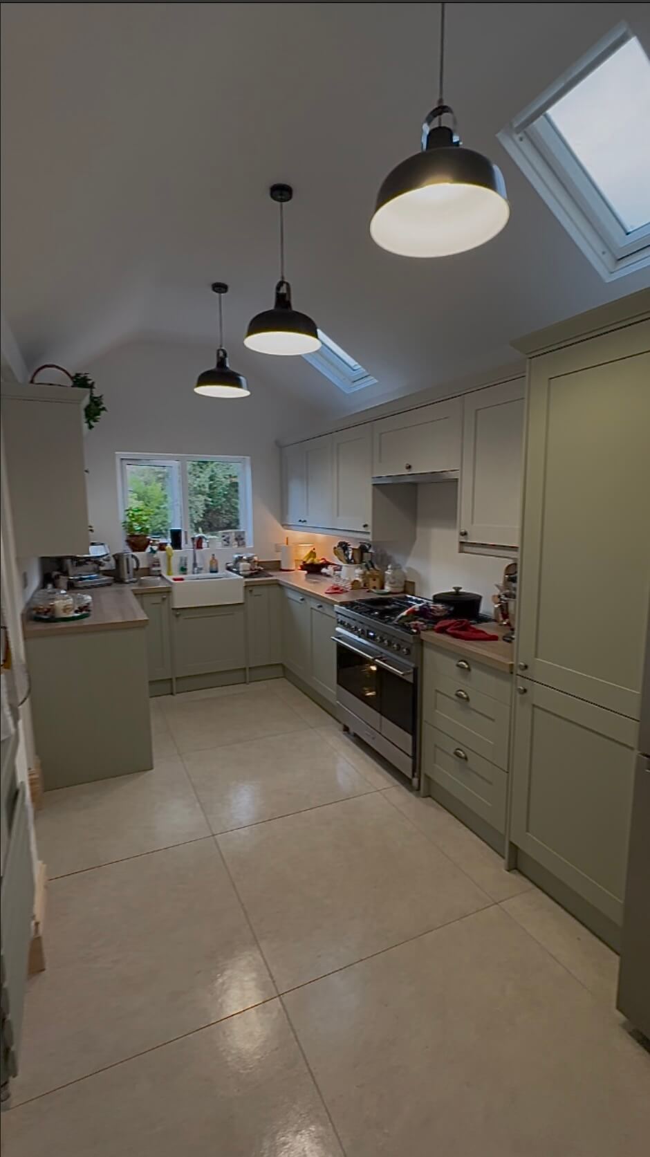 Modern kitchen with large granite tiles and beige grout